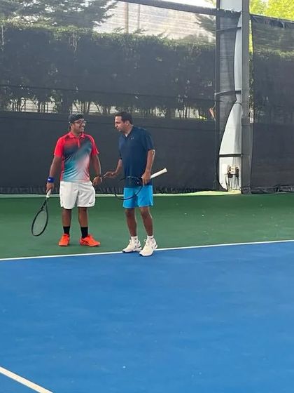 Players discussing strategy between games during a doubles match. Our league encourages tactical thinking and effective teamwork.