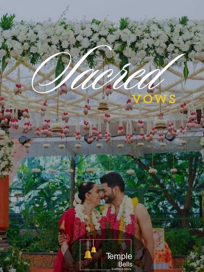Sacred vows exchanged under a canopy of white flowers and hanging lotus buds. This image captures the serene and divine atmosphere we create for your wedding ceremony.