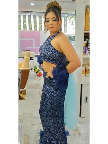 Another angle of our client's party look, showing how the hairstyle and makeup look from the side. The high bun and flawless makeup are designed to last throughout any event.