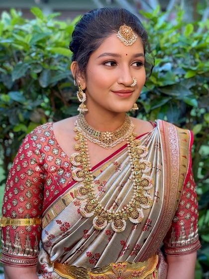 A side profile that showcases the elegant updo and the intricate details of the antique-finish jewellery.