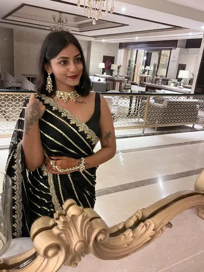 This black saree with delicate gold and silver stripes is one of my favorites for wedding events. It's classic, elegant, and easy to style for a sophisticated look.