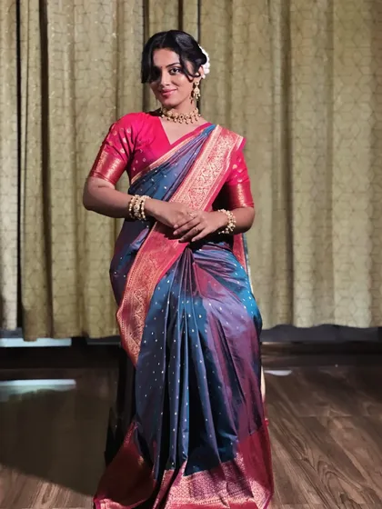 A seated pose can be very elegant in a saree. I ensure the drape looks just as neat and flattering when sitting, with the pleats falling gracefully without bunching up. This is a key consideration for bridal and event draping.