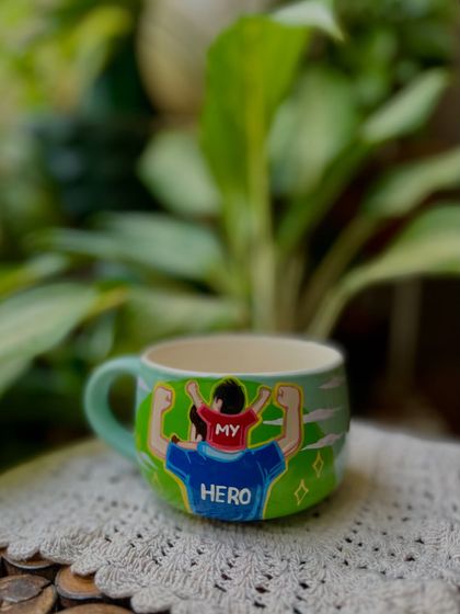 "My Hero." A Father's Day mug showing a son on his dad's shoulders.