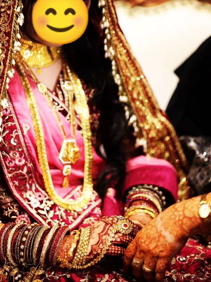 A full shot of the bride in her stunning outfit, with her dark henna adding a traditional touch to her look.