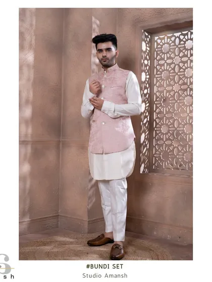 This rose pink bundi set is perfect for daytime events and engagements. The jacket features delicate, all-over hook embroidery, paired with a classic white kurta for a fresh look.