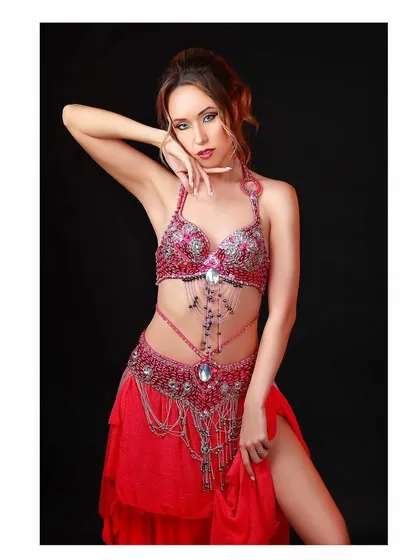 Another pose from the belly dancer's portfolio, showcasing her elegant hand gestures and intricate costume.