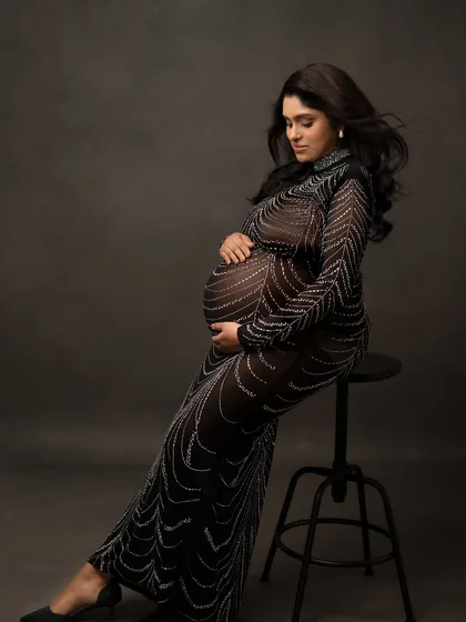 A seated pose in the embellished gown, showing its versatility and how it creates a beautiful shape.