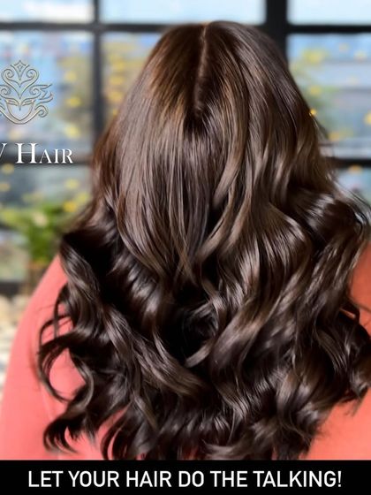 Let your hair do the talking. This deep, voluminous brown color is a statement in itself.