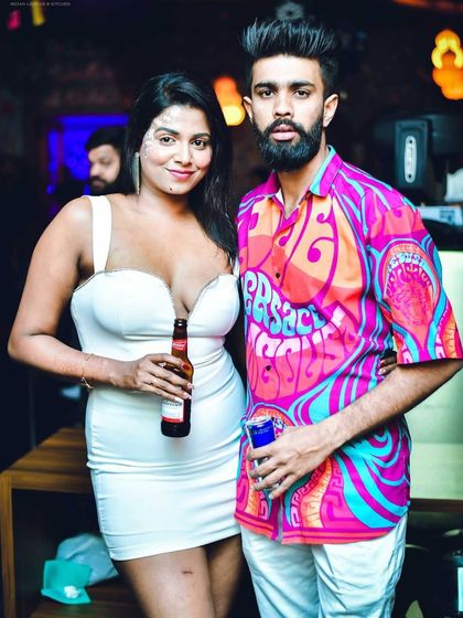 A stylish couple enjoying the Saturday night vibe at Badmaash.