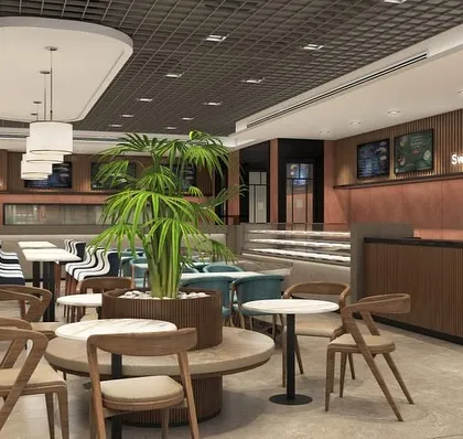 This 3D render shows our initial concept for the Haldiram's restaurant in Pitampura. The design proposed a central planter, a mix of seating types, and a warm, earthy color palette to create a modern and inviting dining space.