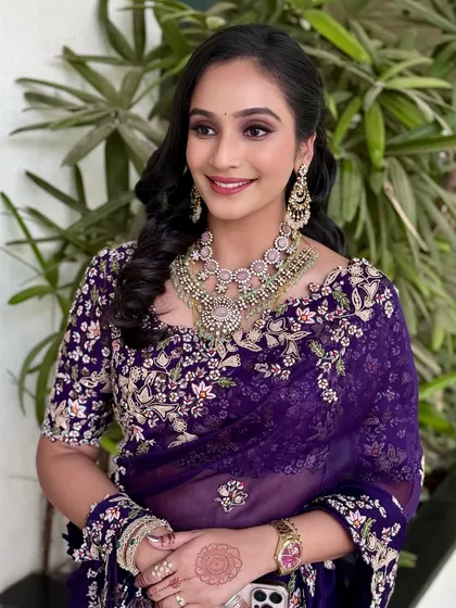 A smiling portrait that shows off the beautiful side-swept curls and statement earrings.