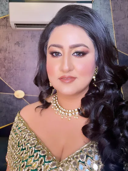 A confident and glamorous portrait. The makeup is bold yet refined, with a focus on defined eyes and a glowing complexion.