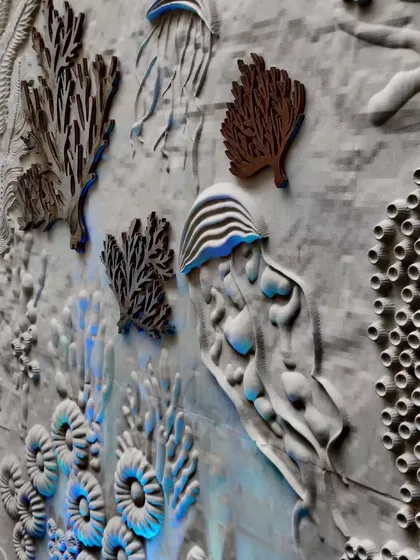 A close-up of the finished coral wall. You can see the different layers and shapes, from delicate sea fans to brain corals and jellyfish. The three-dimensional quality of the piece was meant to draw people in and make the issue of coral bleaching feel more tangible and real.