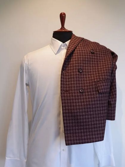 This classic woollen piece features chequered patterns and a double-breasted style, a perfect addition to your formal wardrobe.