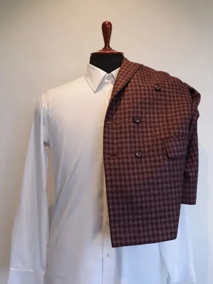 This classic woollen piece features chequered patterns and a double-breasted style, a perfect addition to your formal wardrobe.