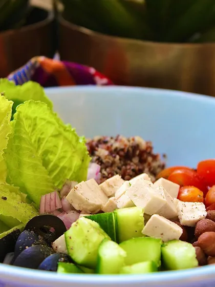 A close-up of the wholesome ingredients in our High Protein Salad Bowl. The silken tofu, crisp cucumber, and juicy cherry tomatoes are ready to be tossed into a nourishing feast.