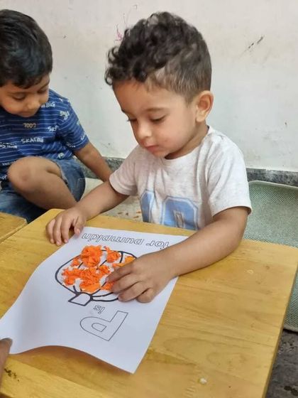 A child carefully works on a craft, showing the focus and creativity that our summer camp activities inspire. Every project is a chance to learn and grow.
