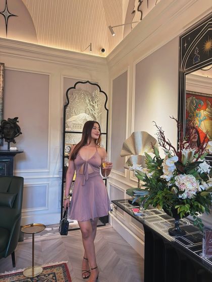 A dusty rose mini dress with a keyhole detail, styled for a classic and elegant evening event.