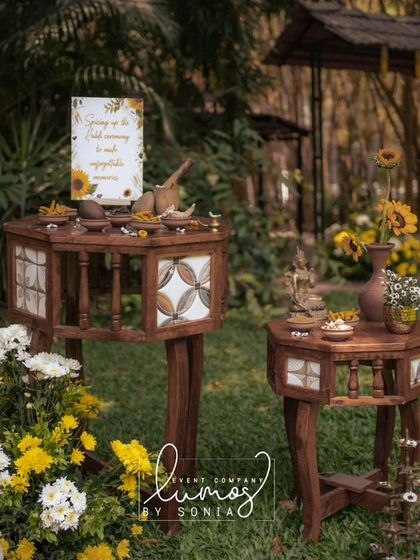 Another angle of the sunflower-themed Haldi decor, with traditional wooden furniture and floral arrangements.