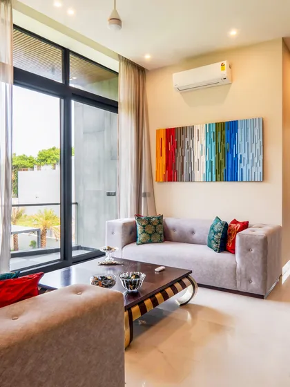 Where vibrant vibes meet farmhouse chic. This drawing lounge in our Chattarpur project uses pops of color, comfortable furniture, and creative art to create a space that is full of energy and comfort.