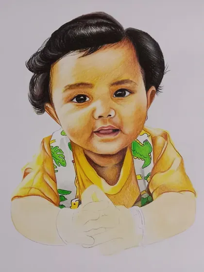 The finished baby portrait, un-framed. The yellow shirt and dinosaur-print bib add a playful touch to this adorable sketch.