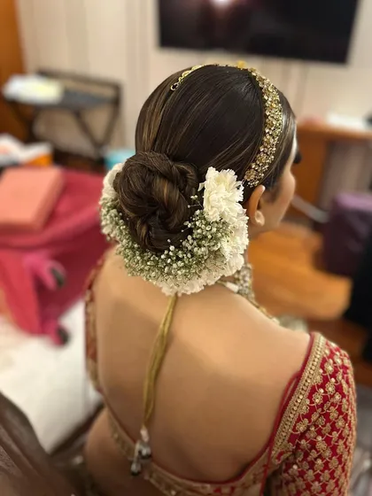 Another angle of the classic bridal gajra bun. You can see how the highlights in the hair add dimension to the twists of the bun.
