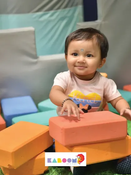 The proud smile of a little builder. Our soft blocks are safe and easy for tiny hands to handle.