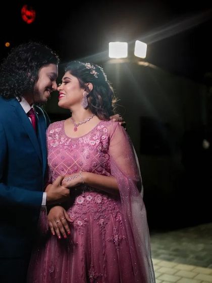 A full-length portrait of a couple at their reception, capturing their elegant outfits and the romantic ambiance of the night.