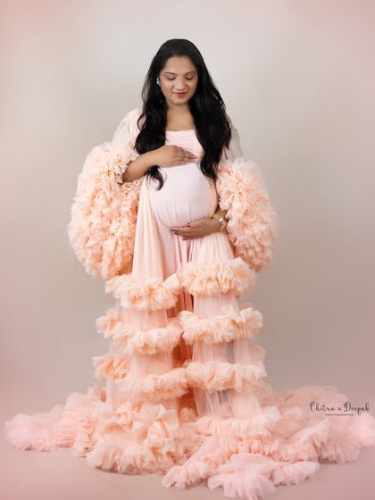 Peachy perfection. This full-body shot showcases the incredible volume and texture of one of our most glamorous ruffled gowns.