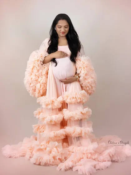 Peachy perfection. This full-body shot showcases the incredible volume and texture of one of our most glamorous ruffled gowns.