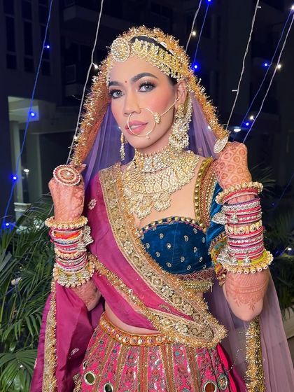 A full-length view of this royal Marwari bridal look from a campaign. The makeup is glamorous and powerful, matching the regal outfit.