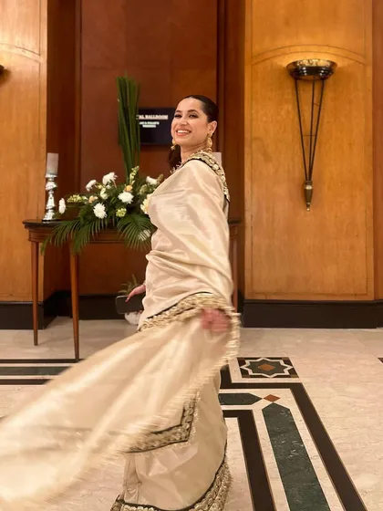 The movement of a saree is just magical. This shot captures the beautiful drape and flow of the silk tissue fabric, highlighted by the intricate zari border.