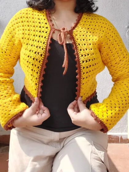 This is the Odette Cardigan, a beautiful piece made with a classic granny stitch pattern and finished with a contrasting border.