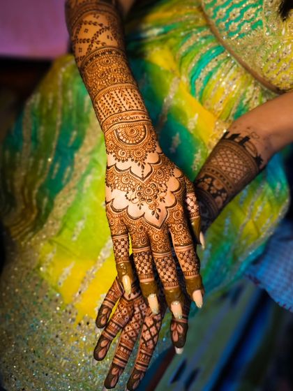 A close-up of the wrist and hand, showing the delicate details and shading in the design.