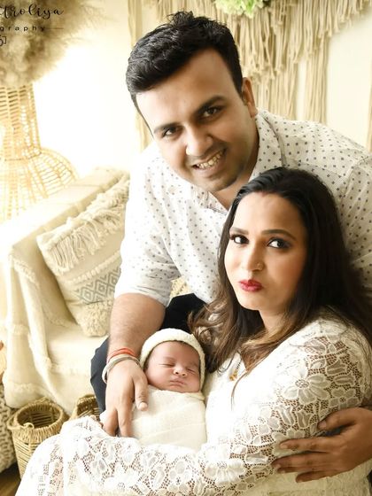 This family portrait uses my studio's boho-chic setup. The natural textures and warm tones create a cozy and inviting atmosphere for a relaxed newborn family session.