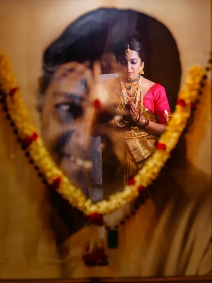 A deeply emotional and artistic shot. I used a double exposure technique to blend a portrait of a loved one with the bride, creating a poignant image that honors family members who are present in spirit.
