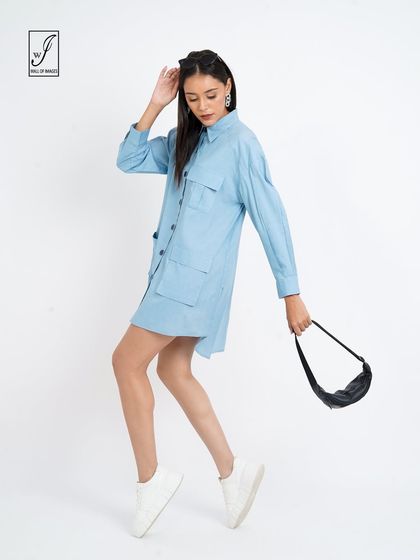 A walking pose with a handbag, showing how the dress can be styled for a day out.