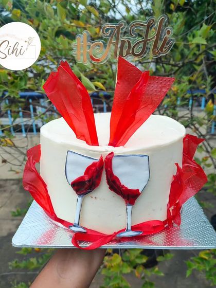 Keep the wine flowing. This cake is perfect for a cocktail party or a wine lover, featuring painted wine glasses and dramatic red rice paper sails.