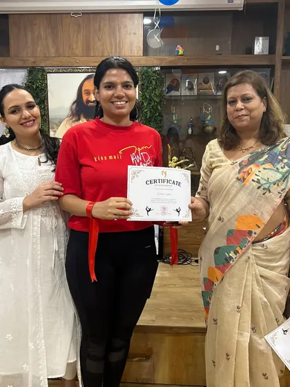 A member of team "Yogini" proudly displays her award. Our events are a great way to build camaraderie and celebrate our collective achievements.
