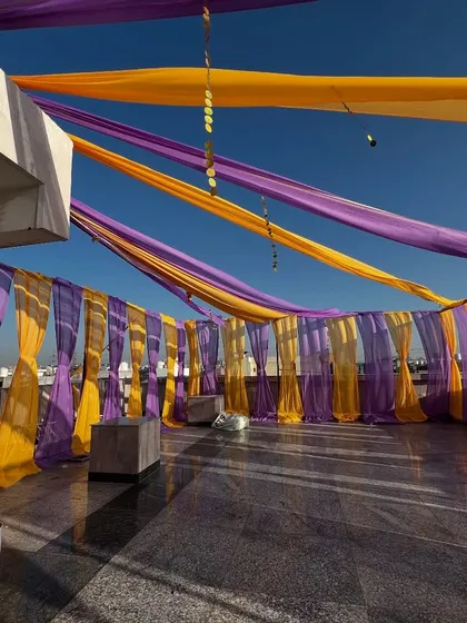 For rooftop parties, we can install these beautiful canopies with colorful drapes that flutter in the wind, creating a festive atmosphere.