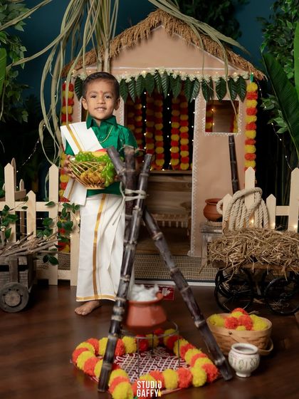 The little boy holds a basket of offerings for the Pongal festival.