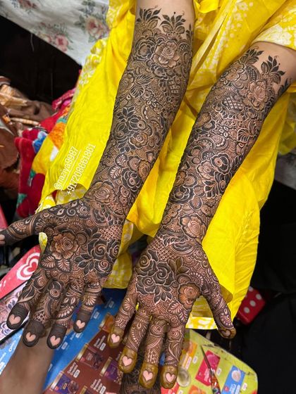 A full bridal design with tiny hearts hidden in the fingertips. It's these small, personal touches that make the mehendi special.