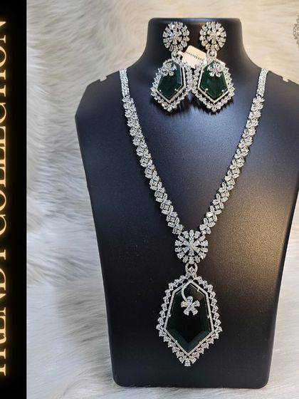 This American Diamond necklace set with a large emerald green pendant is part of our trendy collection. It's a perfect rental for adding a touch of glamour to any occasion.