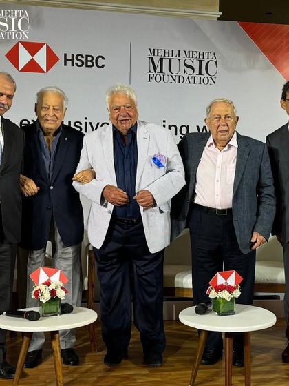 The esteemed panelists pose for a group photo after an evening of lively conversation about the golden years of cricket.