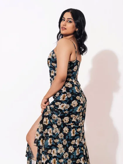 Another angle of the floral dress look. The soft waves in her hair and the glowing skin create a romantic and feminine vibe.