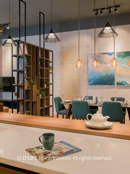 This open-plan living and dining space is a masterclass in understated luxury. A neutral palette is brought to life with rich textures, layered lighting, and pops of color from the teal dining chairs.