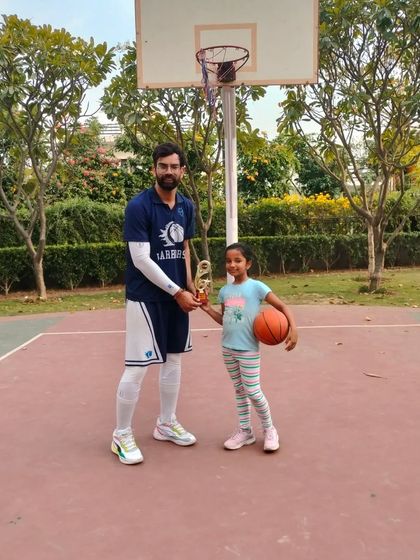 Presenting a trophy to a promising young player at a skill development Ranking Day. Her focus and determination were impressive.