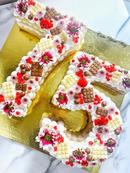 A grand 75th milestone celebration calls for a grand cake. I designed this unique number-shaped cake, loading it with fresh flowers, assorted chocolates, and buttercream swirls. It’s a delicious and personal way to honor a special age.
