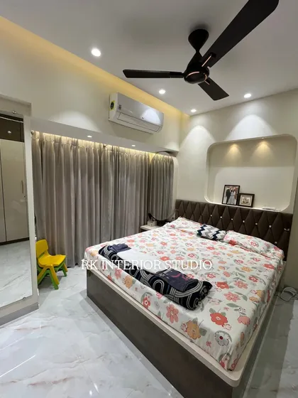 This angle shows the full layout of the bedroom, including the bed, wardrobe, and the full-length curtains that add softness to the room.