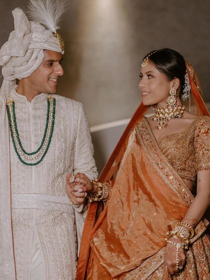 Glowing in love. This bride's rustic orange lehenga was paired with warm, bronzy makeup for a stunning combination.